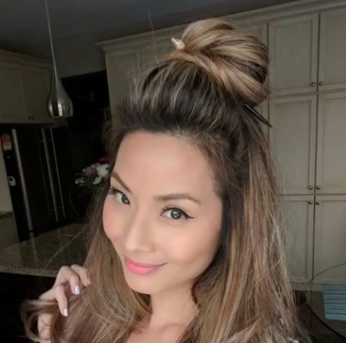 Actress Kerry LaiFatt wears a Tidal Hair Stick to hold up her topknot hairstyle.
