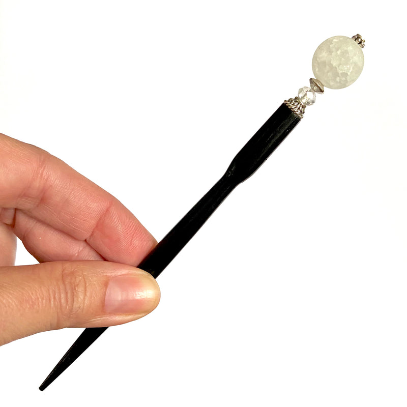 A close up of the Elodie Hair Stick made from frosted white crackle quartzite beads.
