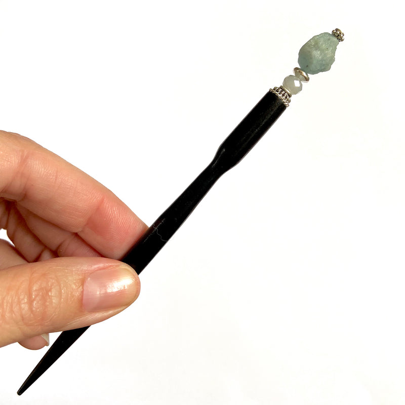 A close up of our Skye Hair Stick made from an aquamarine nugget