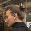 A brunette woman wears a Farah Tidal Hair Stick 