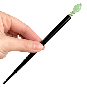 The large size of our Remy hair sticks made from oval green swirl Czech glass beads. 