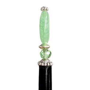 The side view of our Remy hair sticks made from oval green swirl Czech glass beads. 