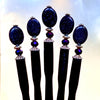A set of five Andromeda Tidal Hair Sticks made from blue goldstone. 