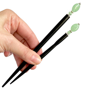 The large and standard sizes of our Remy hair sticks made from oval green swirl Czech glass beads. 
