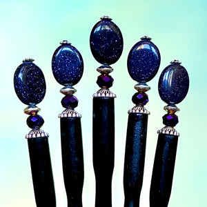 A set of five Andromeda Tidal Hair Sticks made from blue goldstone. 