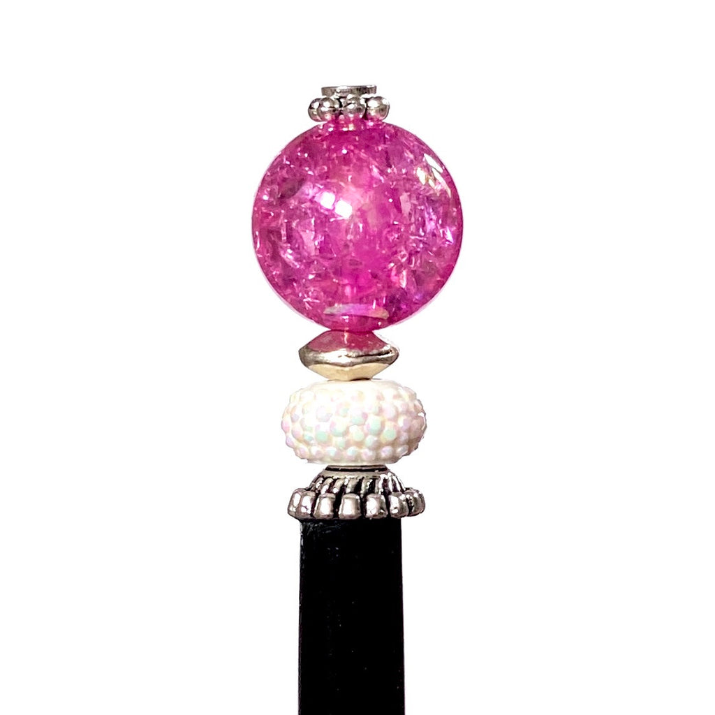 A close up of our Chelsea Hair Stick made with hot pink crackle glass beads