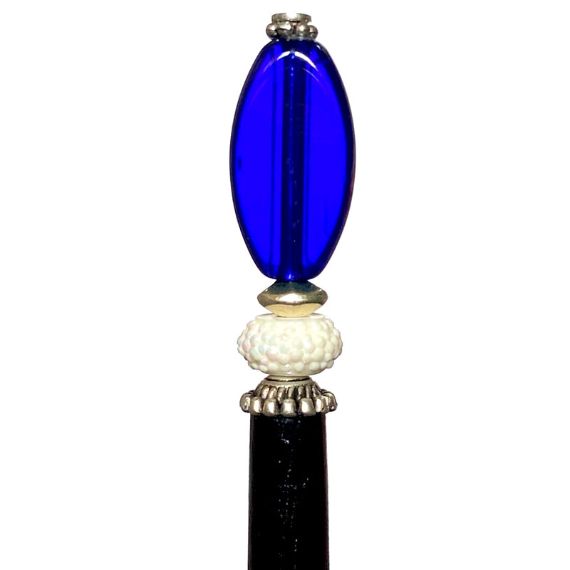 A close up view of the Stella Tidal Hair Stick made from cobalt blue glass beads.
