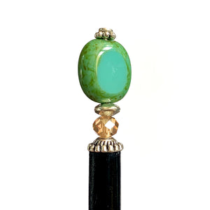 A close up of the Dakota Tidal Hair Stick made from a turquoise Czech glass bead