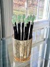 A group of our handmade Remy hair sticks made from oval green swirl Czech glass beads. 
