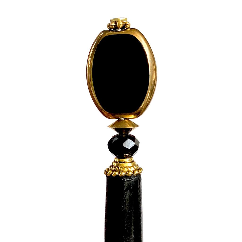 A close up of our Trinity hair sticks made from gold rimmed black Czech glass beads.  