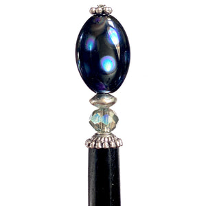 A close up of the Melanie Tidal Hair Stick made from black Czech glass beads