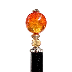 A close up of our Maya Hair Stick made with orange-yellow crackle Czech glass beads