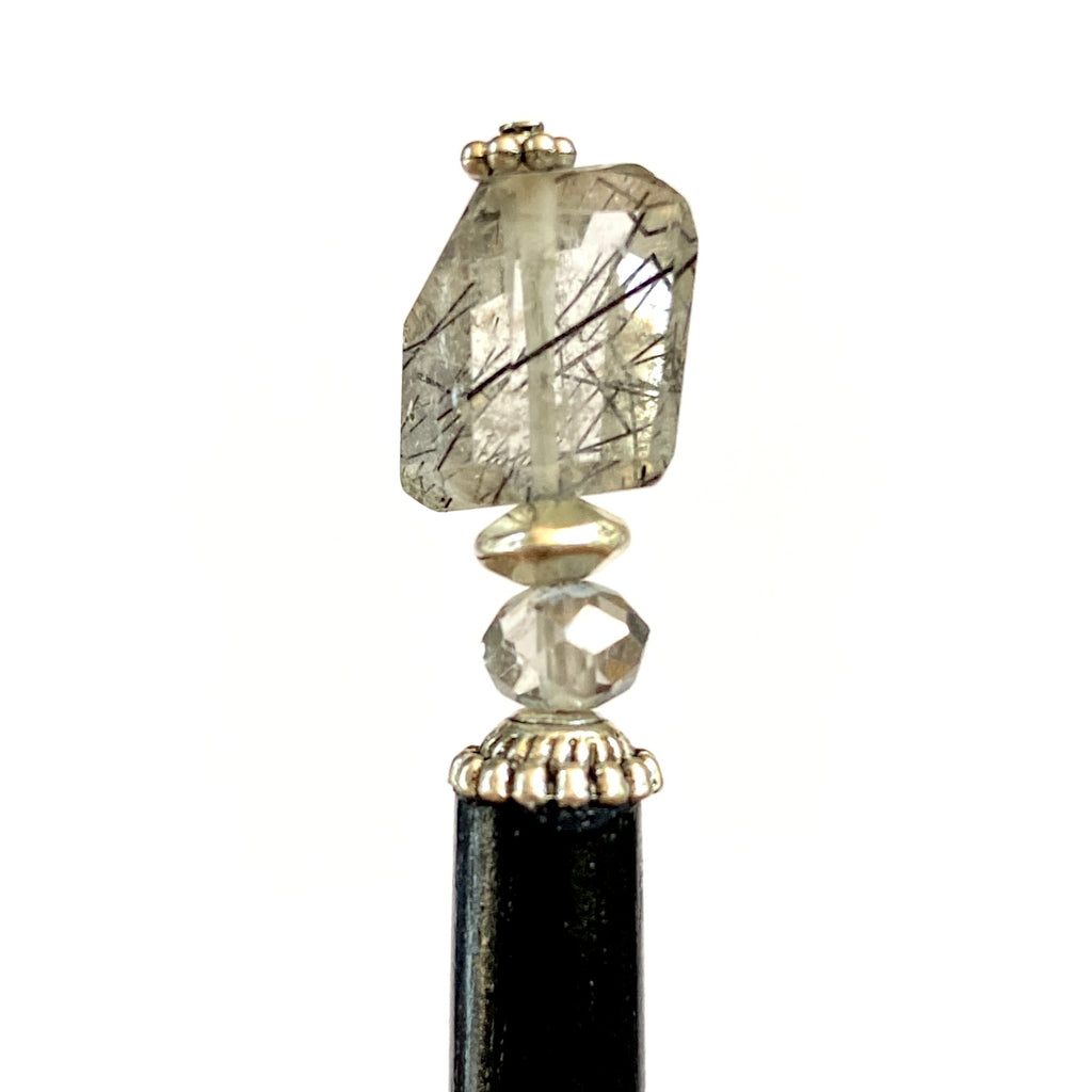 A close up of our Palmer Hair Stick made from black rutile quartz stone