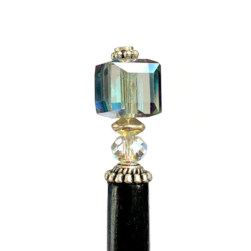 A close up of the Marley Tidal Hair Stick made from iridescent blue glass beads