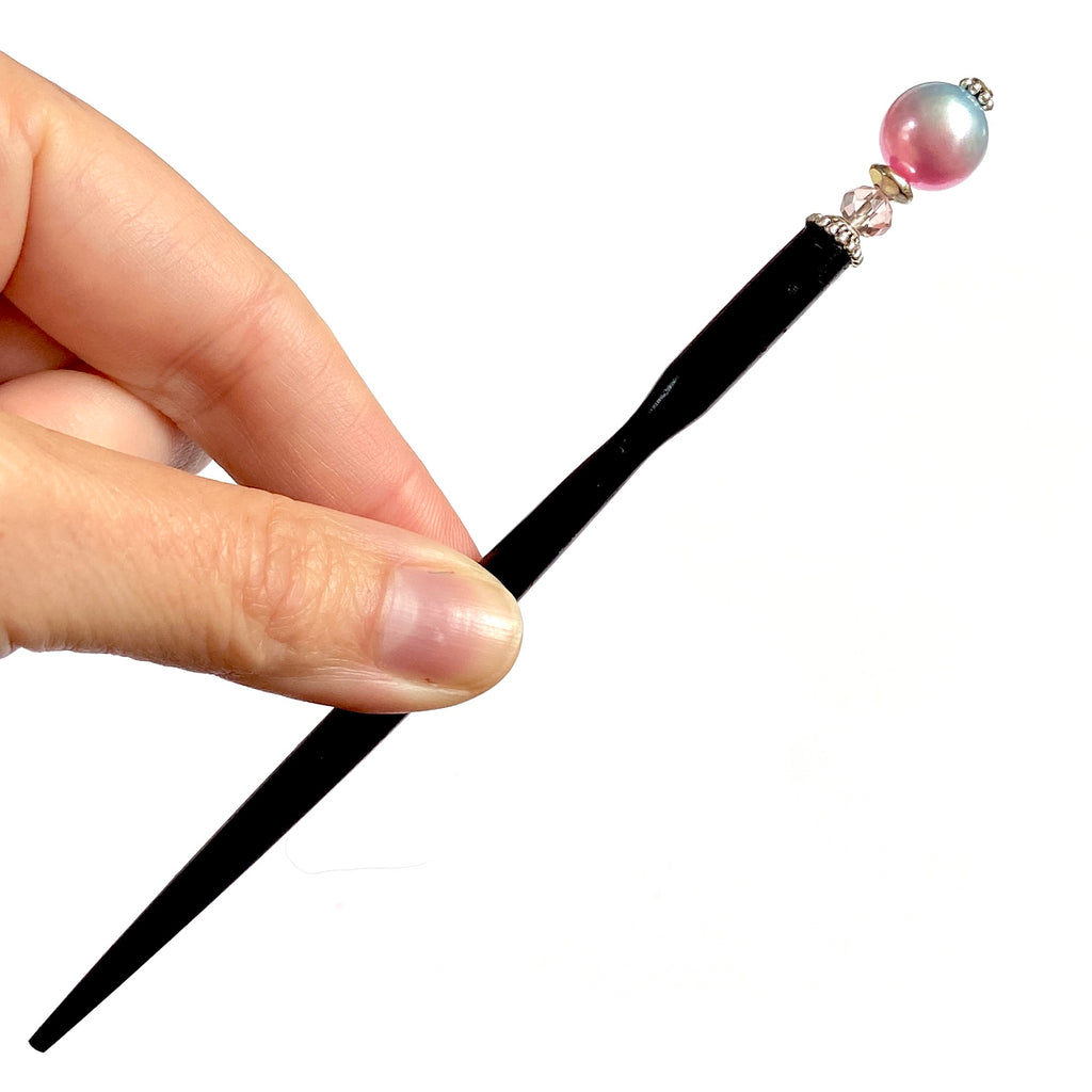 The standard size of our Olivia Hair Sticks made from pastel pink and blue acrylic bubblegum beads.