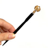 A full shot of Abigail Tidal Hair Stick with Champagne-colored glass.