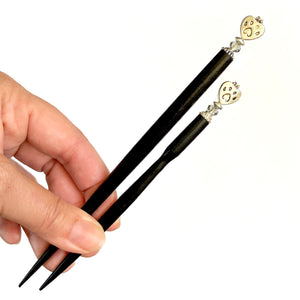 the standard and large sizes of our Bailey Hair Stick made with a heart-shaped dog paw print metal bead and Swarovski crystal.