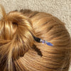 A blonde woman wearing a Claudia Tidal Hair Stick
