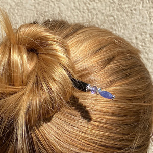 A blonde woman wearing a Claudia Tidal Hair Stick