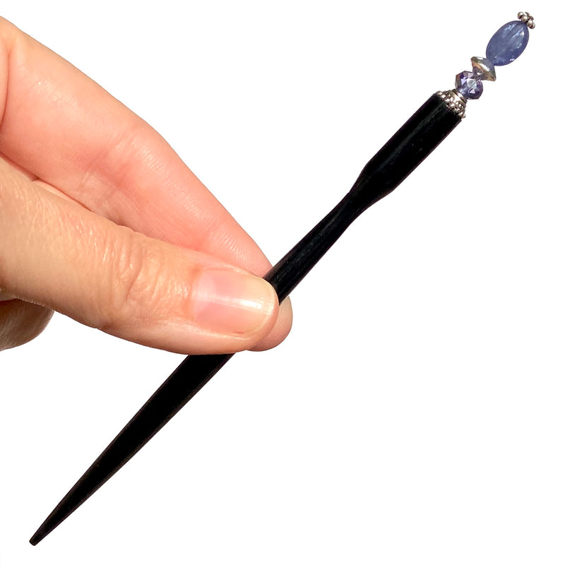 A close up of our Claudia Hair Stick made from Tanzanite Stone and matching Swarovski crystal