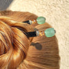 A blonde hair bun is secured by two of the Daliah Hair Stick made from aqua African Recycled Glass beads.