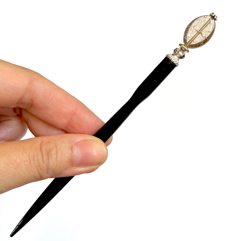 the standard size of our Dharma Tidal Hair Stick made from gray brown bubbled glass