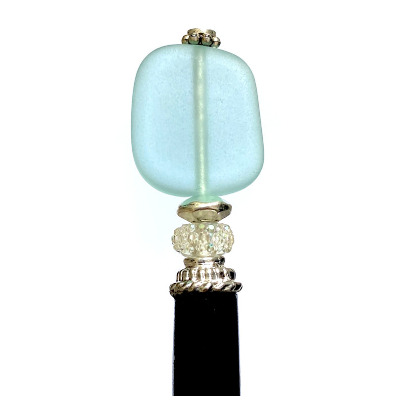 A close up of our aqua Erin Hair Sticks made from cultured seaglass.