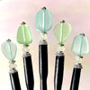 A group of just-made aqua and green Erin Tidal Hair Sticks.