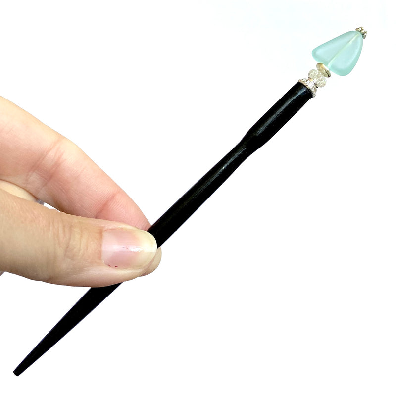 A close up of our aqua Erin Hair Sticks made from cultured seaglass.