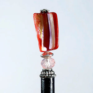The Eve Tidal Hair Stick made from pink mother of pearl shell beads.