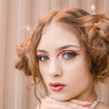 A milennial woman wearing spacebuns in her hair using of our Farah Hair Sticks.