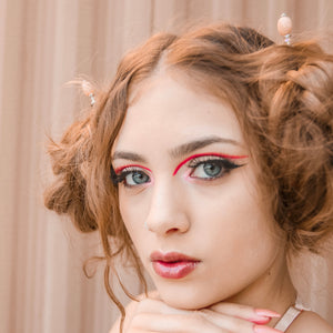 A milennial woman wearing spacebuns in her hair using of our Farah Hair Sticks.