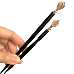 The standard and large sizes of the Gemma Hair Sticks