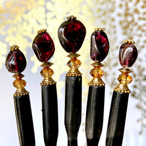 Five of our Gia hair sticks made from garnet nuggets.