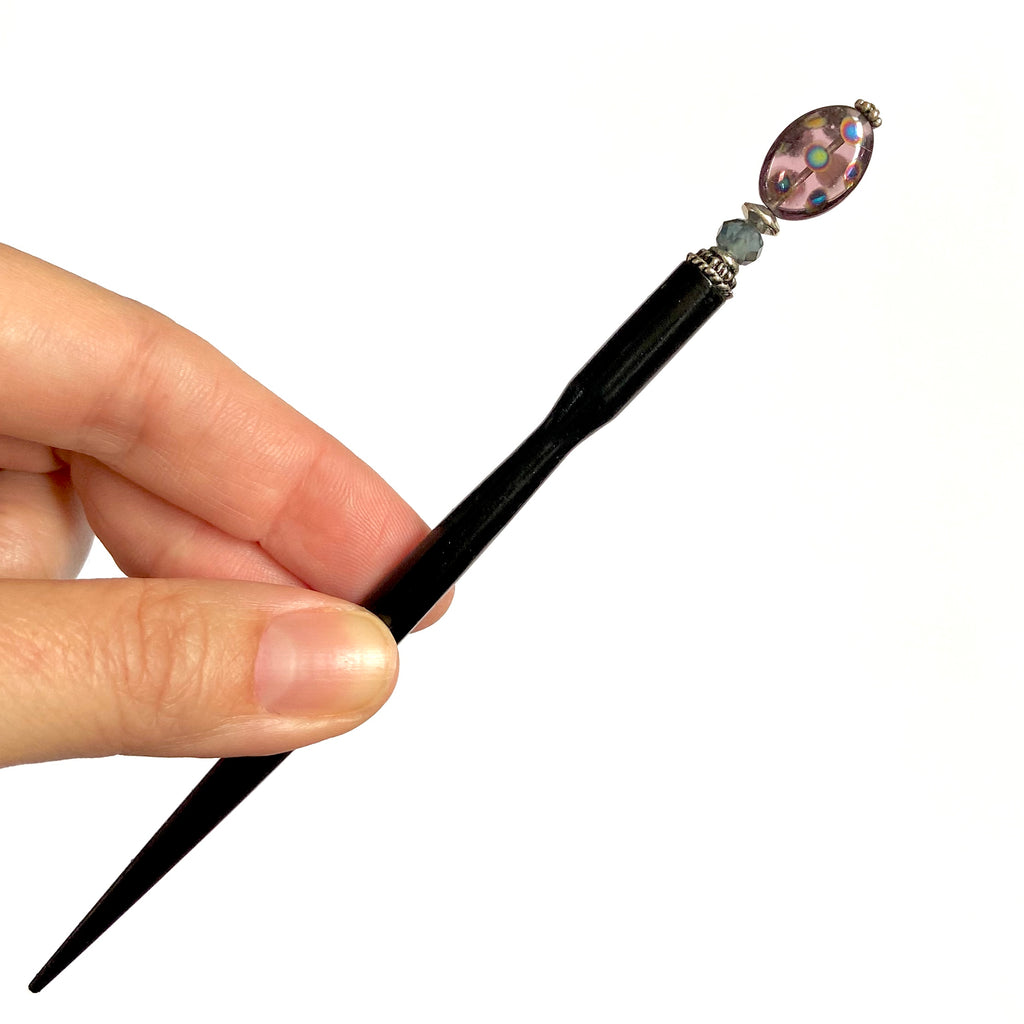 A full picture of the Juno Tidal Hair Stick made from purple Czech glass beads.