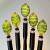 Five of our Kaja Hair Sticks made from green swirl Czech glass beads