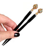 A pair of the Kathleen Hair Stick made from a gold Czech glass bead
