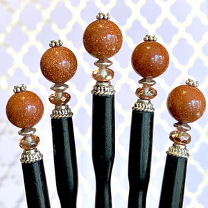 Five of our Kennedy Hair Stick made from copper-colored goldstone.