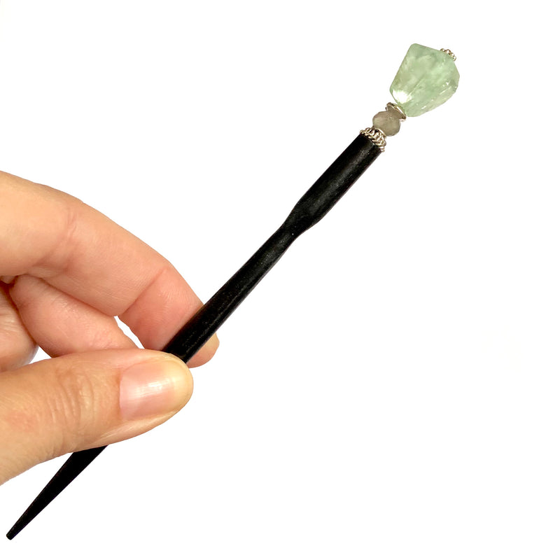 A close up of our Kira Tidal Hair Stick made from green fluorite nugget stone