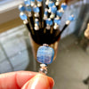 In the process of making the Kya Hair Sticks, Katie holds up a partly made one. 