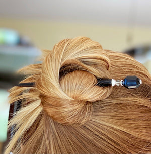A woman wears one Laura Hair Stick made with Onyx nuggets and Austrian crystal accent.