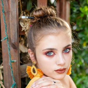 A brunette millennial woman wears a bun using the Luna Tidal Hair Stick made from Rainbow Moonstone nugget beads.