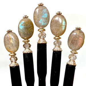 Five A close up of the Malia Tidal Hair Stick made from gray Labradorite stone beads.