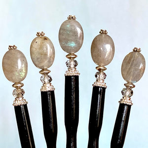 Five A close up of the Malia Tidal Hair Stick made from gray Labradorite stone beads.
