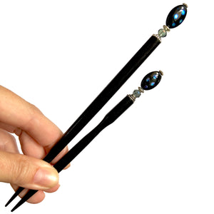 The standard and large sizes of the Melanie Tidal Hair Stick made from black Czech glass beads.