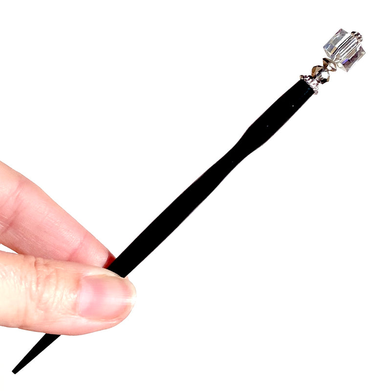 A close up of the Nicole Tidal Hair Stick made with an iridescent clear square bead and crystal accent