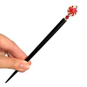 The large size of our Noelle Hair Stick made from a glass bead that looks like peppermint candy.