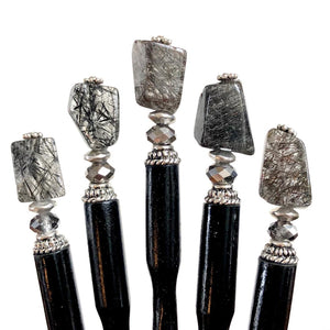 A close up of 5 of our Palmer Hair Sticks made from black rutile quartz stone.