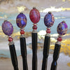 Five of the Petra Tidal Hair Sticks made with purple jasper stone beads.