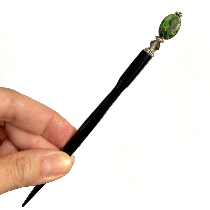 A full view of the Quinn Tidal Hair Stick made from green Jasper stone beads.